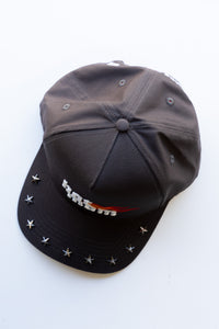 Black cap with decorative elements on a white background