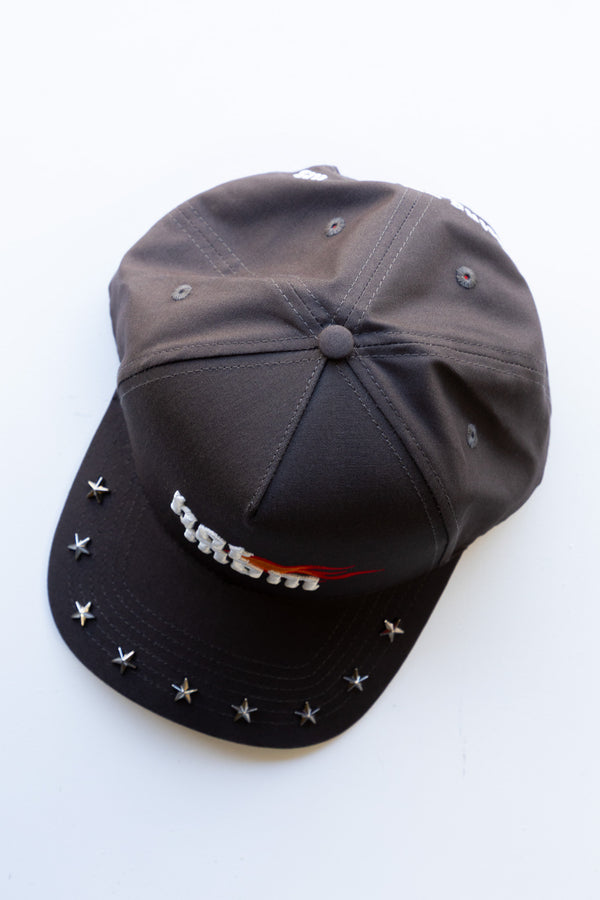 Black cap with decorative elements on a white background