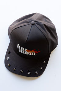 Black cap with 'hot mom' text and star embellishments on a white background