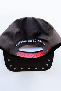 Black cap with 'Raising Wild Ones' text on a white background