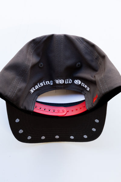 Black cap with 'Raising Wild Ones' text on a white background