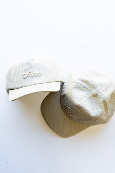 Two caps, one white and one beige, on a white background