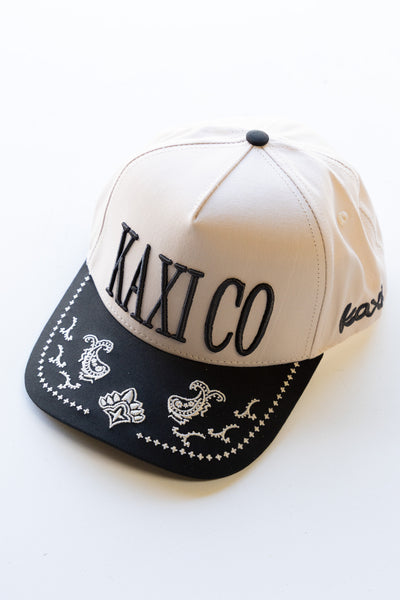 Cap with 'KAXI CO' text on a white background