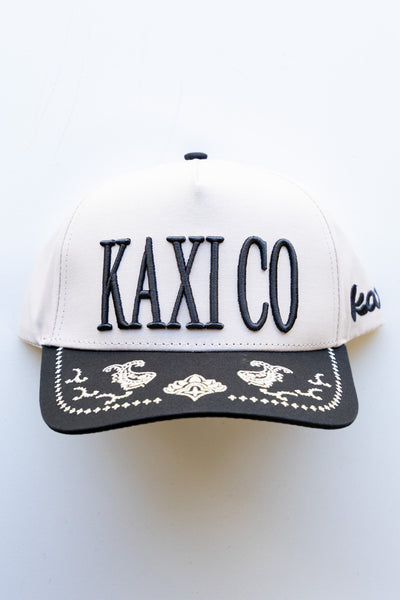 White cap with 'KAXI CO' text on a white background
