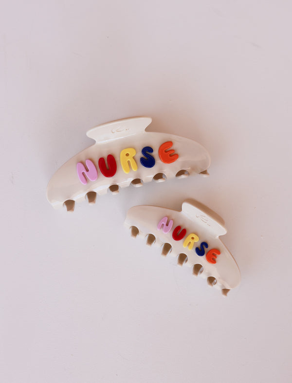 Colorful 'NURSE' hair clips on a light background