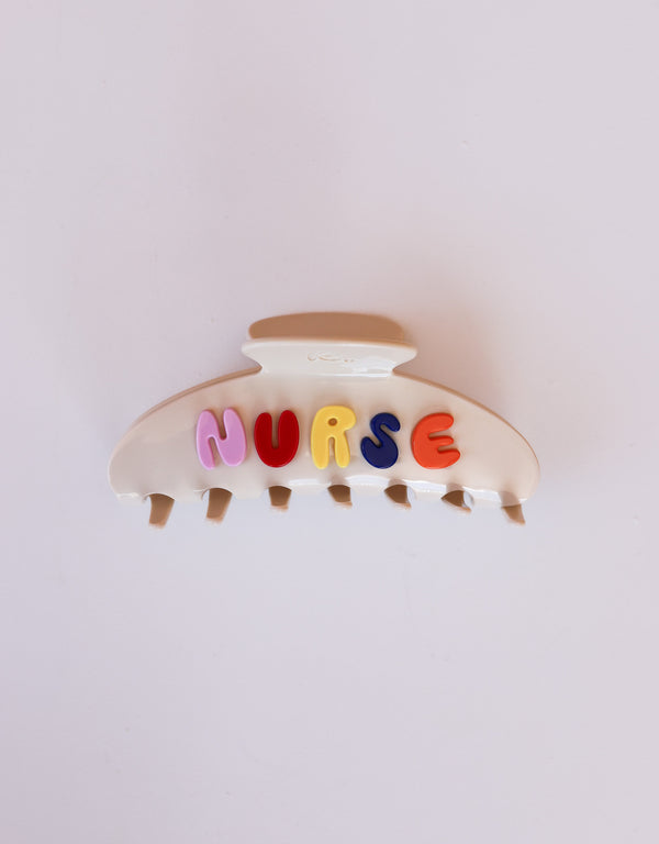 Hair clip with colorful letters spelling 'NURSE' on a white background