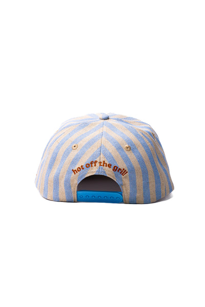 Striped cap with 'hot off the grill' text on a white background