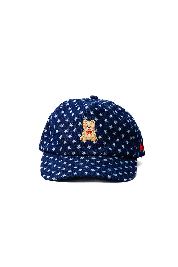 Navy blue cap with white star pattern and teddy bear embroidered on the front on a white background