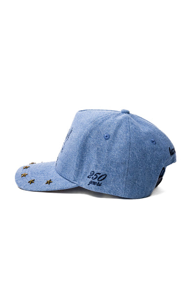 Blue denim cap with "250 years" embroidered  on a white background